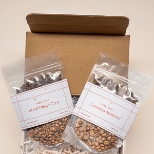 Holiday gift for coffee lover. Two giftable coffees in clear bags and holiday packaging.