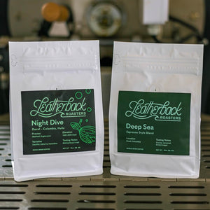 Two bags of coffee sitting on a coffee roaster. Half Caf bundle by Leatherback Roasters. Best coffee in Orlando, Florida.