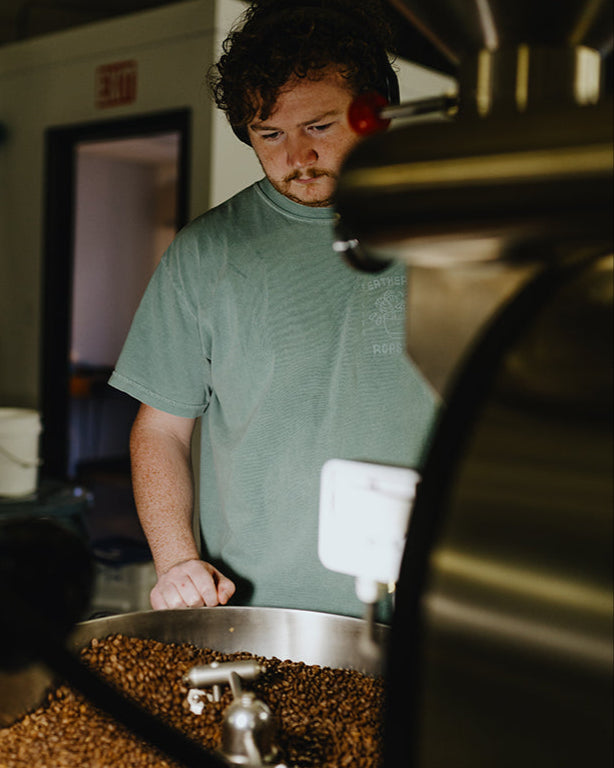 Person working with coffee beans in a roastery