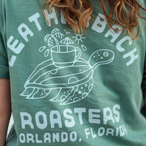 Unisex graphic tee with turtle design on back. Reads "Leatherback Roasters Orlando, Florida."